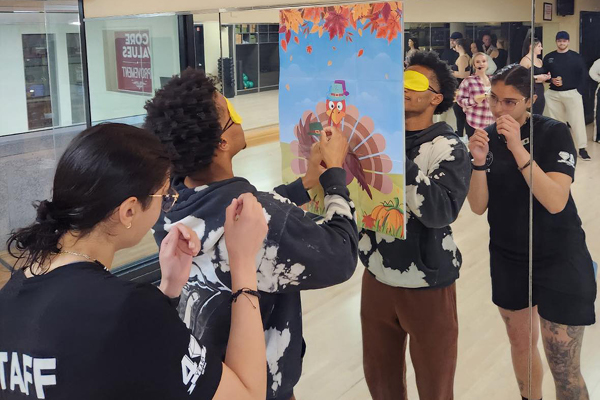 Two FFC Old Town members playing pin the tail on the turkey