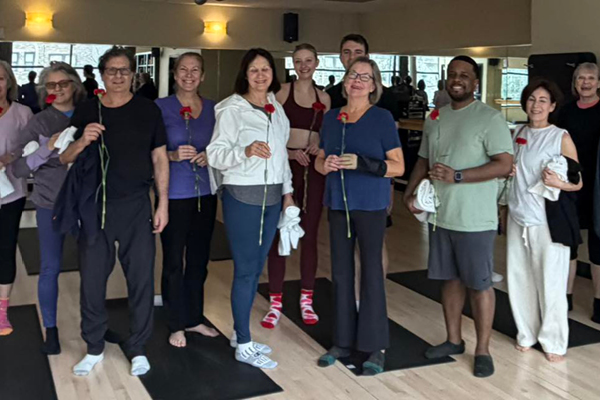Group Photo of FFc Old Town Members holding roses on Valentines Day after Group Fitness Class