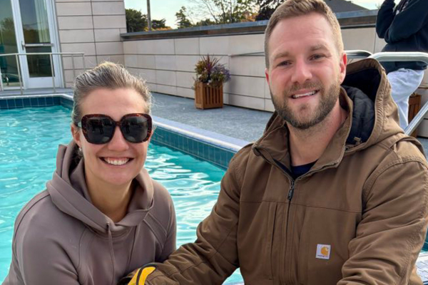 Two members by the ffc park ridge pool deck smiling